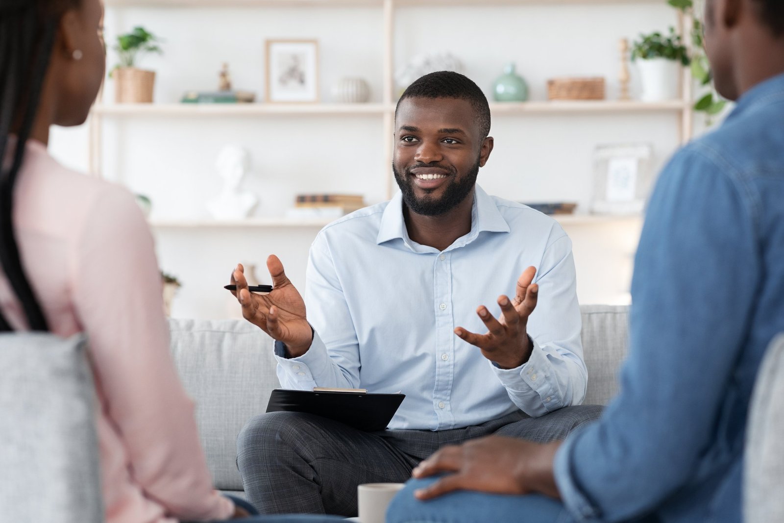 About family psychotherapy. friendly black therapist consulting african american couple at his office